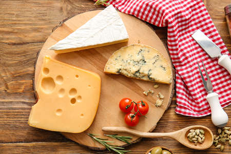 Composition with different types of cheese on wooden background