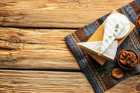 Tasty cheese and dried figs on wooden backgroundの写真素材