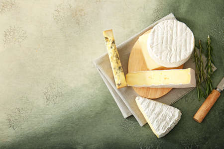 Different types of cheese on color backgroundの写真素材