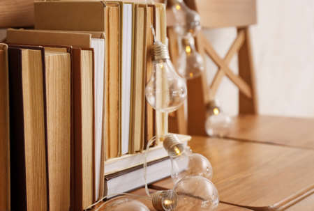 Stack of books with garland on chairs, closeupの写真素材