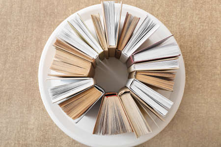 Frame made with stack of books on color backgroundの写真素材