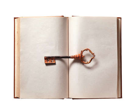 Old book with key on white background