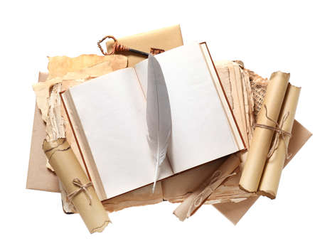 Old book with scrolls and feather on white background