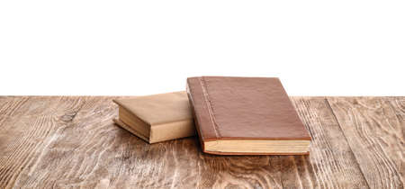 Old books on table against white background