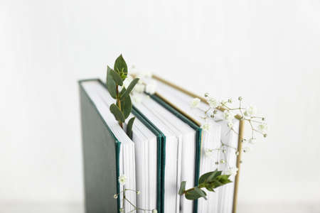 Books with floral decor on white backgroundの写真素材