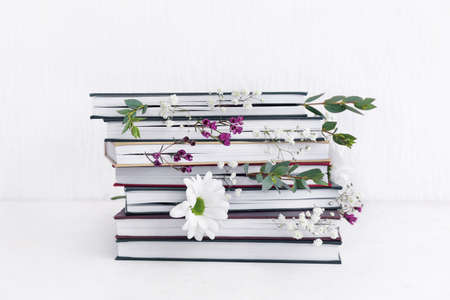 Books with floral decor on white backgroundの写真素材