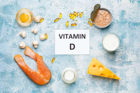Text VITAMIN D and different healthy products on color backgroundの写真素材