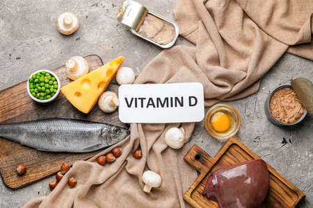Text VITAMIN D and different healthy products on gray backgroundの写真素材
