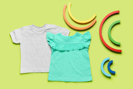 Stylish baby clothes on color backgroundの写真素材