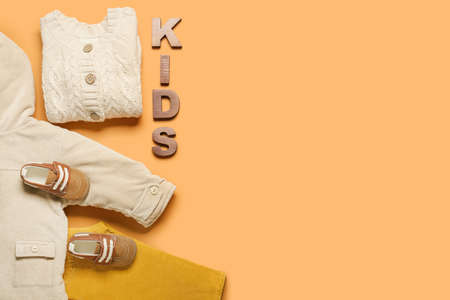 Stylish baby clothes on color backgroundの写真素材