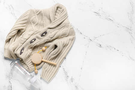 Stylish baby clothes with toy and bottle on white backgroundの写真素材