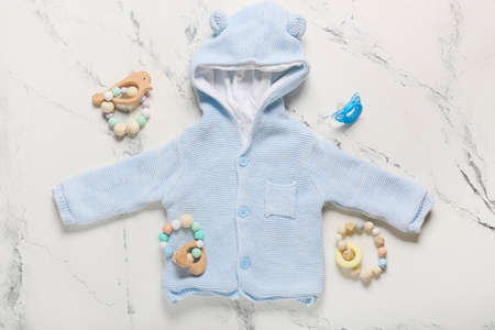 Stylish baby clothes with toys on white backgroundの写真素材