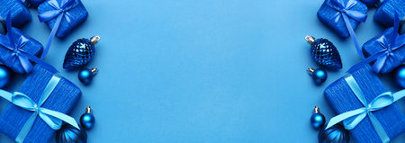Beautiful Christmas gifts with decor on blue background with space for text