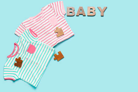 Stylish baby clothes on color backgroundの写真素材
