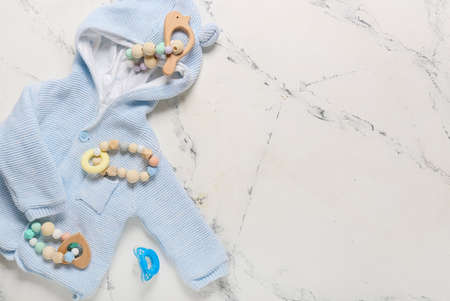 Stylish baby clothes with toys on white backgroundの写真素材