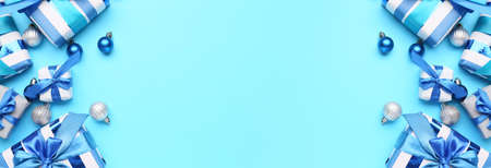 Beautiful Christmas gifts with decor on blue background with space for text