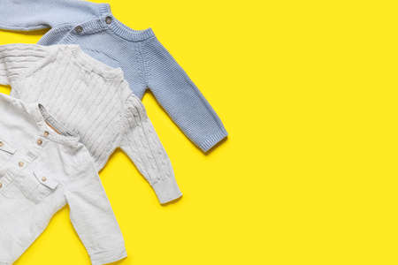 Stylish baby clothes on color background