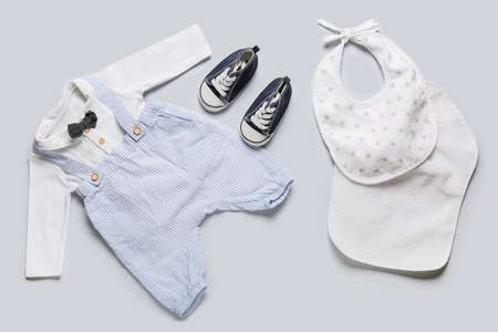 Stylish baby clothes on light backgroundの写真素材