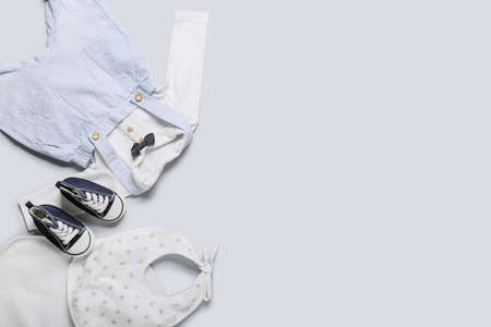 Stylish baby clothes on light backgroundの写真素材