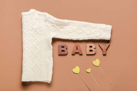 Stylish baby clothes on color background