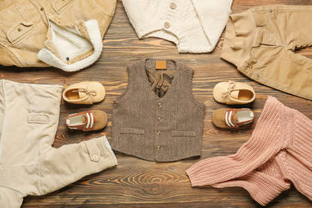 Stylish baby clothes on wooden backgroundの写真素材