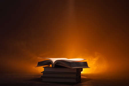Old books on table against dark background