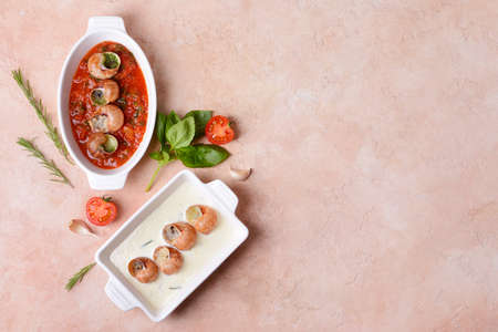 Baking dishes with tasty snails on color backgroundの写真素材