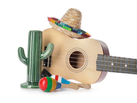 Mexican sombrero, ceramic cactus, maracas and guitar on white background