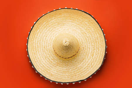 Mexican sombrero on color background