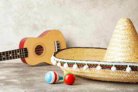 Mexican sombrero, guitar and maracas on grunge backgroundの写真素材