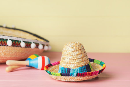 Mexican sombreros and maracas on color wooden backgroundの写真素材