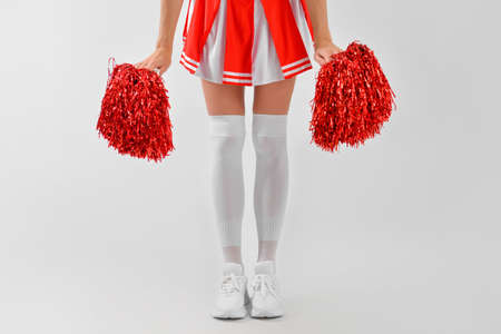 Beautiful cheerleader on light backgroundの写真素材