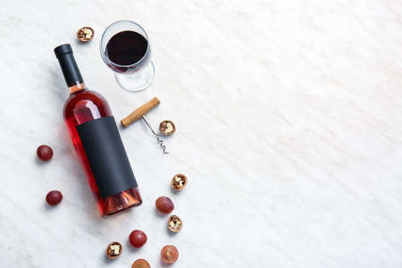 Composition with bottle of wine and snacks on light backgroundの写真素材