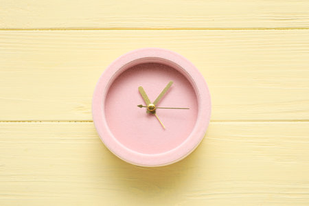 Alarm clock on color wooden background