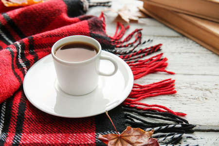Beautiful autumn composition with cup of coffee on light wooden backgroundの写真素材