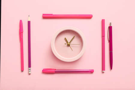 Alarm clock with office supplies on color backgroundの写真素材