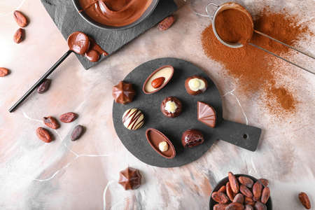 Tasty chocolate candies on grunge background