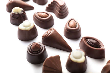 Tasty chocolate candies on white background