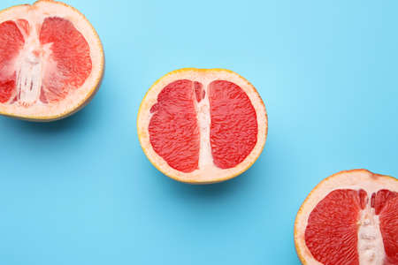 Fresh cut grapefruits on color backgroundの写真素材