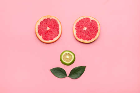 Creative composition of fresh sliced grapefruit and lime on color backgroundの写真素材