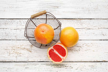 Fresh grapefruits on white wooden backgroundの写真素材