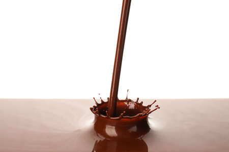 Hot pouring chocolate with splash on white backgroundの写真素材