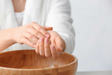 Young woman undergoing spa manicure treatment in beauty salonの写真素材