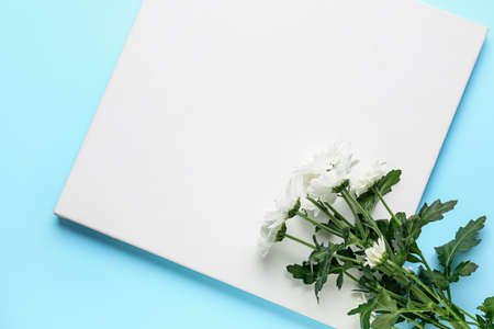 Chrysanthemum flowers with empty board on color backgroundの写真素材