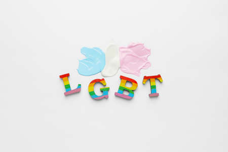 Abbreviation LGBT with paint strokes on white background. Concept of transgender