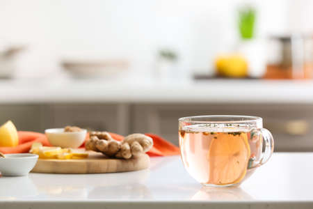 Cup of healthy tea with lemon, ginger and honey on tableの写真素材