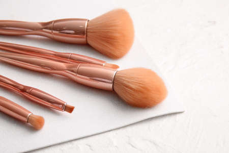Stylish makeup brushes on light backgroundの写真素材