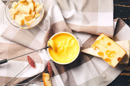 Cheese fondue and different snacks on tableの写真素材
