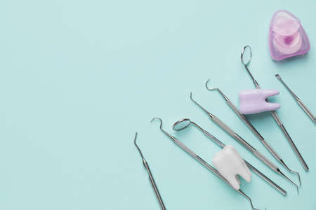 Dentist's tools and plastic teeth on color backgroundの写真素材