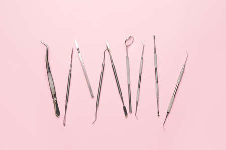 Dentist's tools on color background